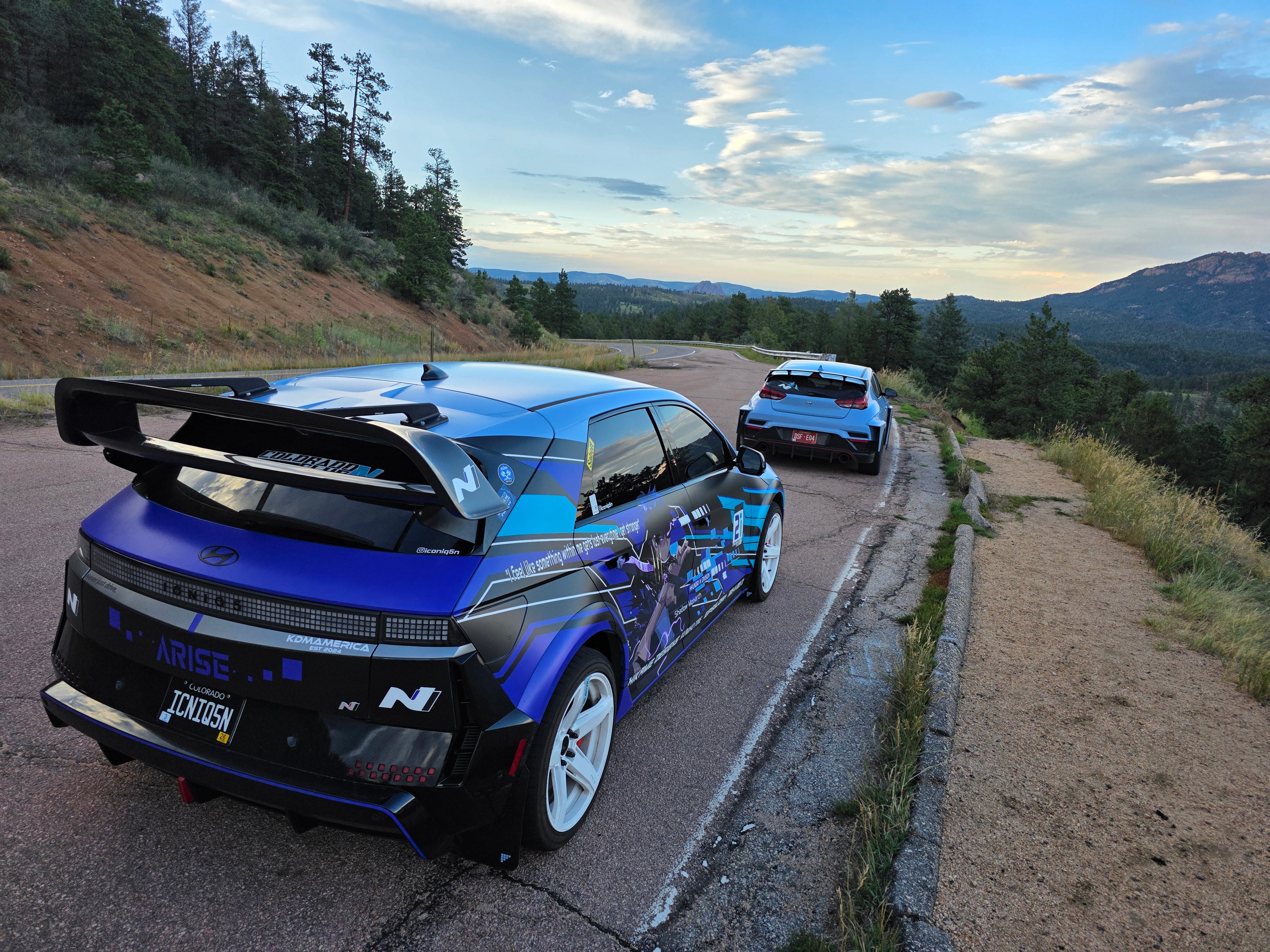 Rear view of a blue Hyundai Ioniq 5N showing the Epsilon+ R1 wing uprights and lower mounting