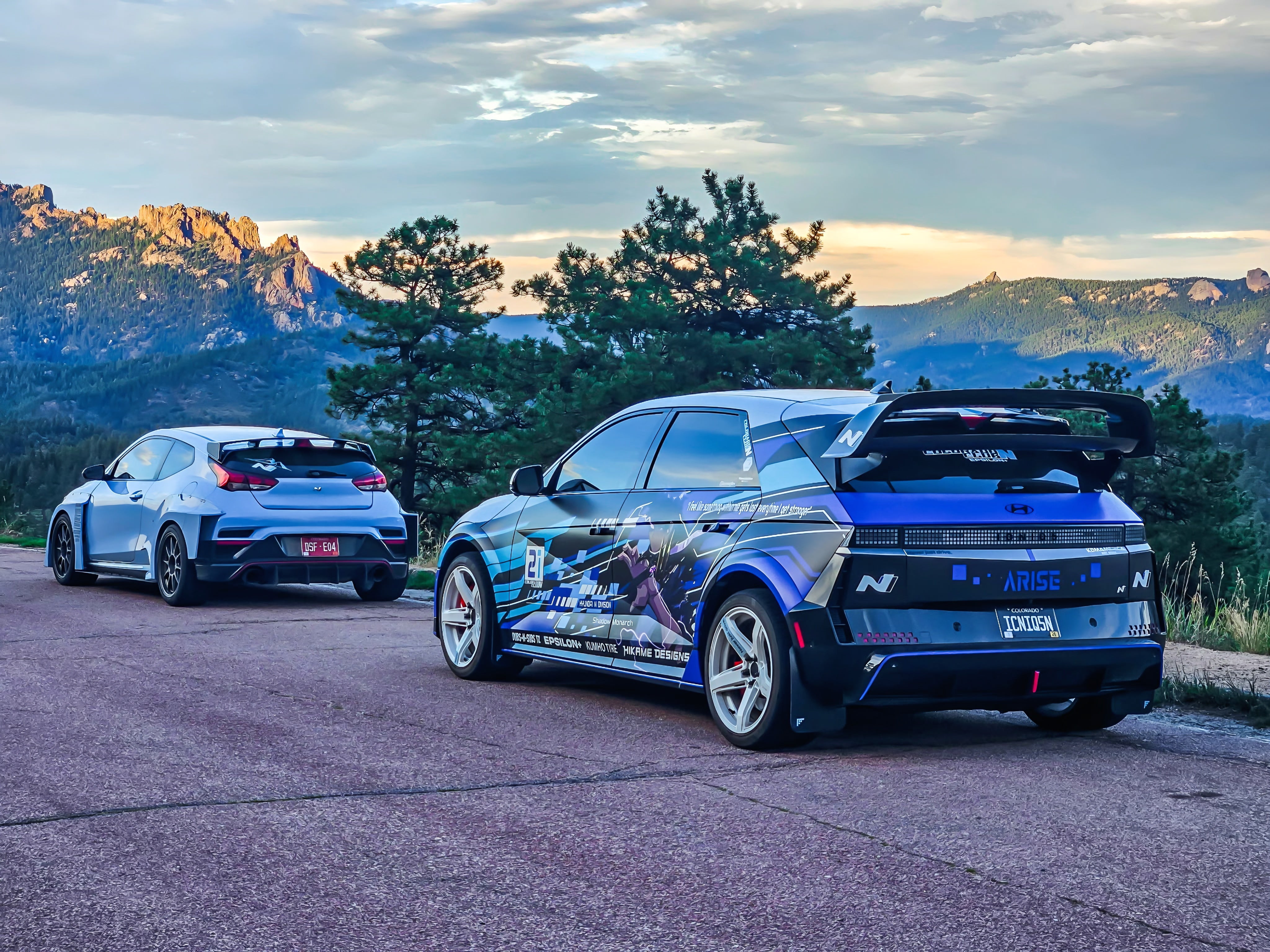 White and blue Hyundai Ioniq 5N builds fitted with Epsilon+ R1 wings, parked on a mountain road
