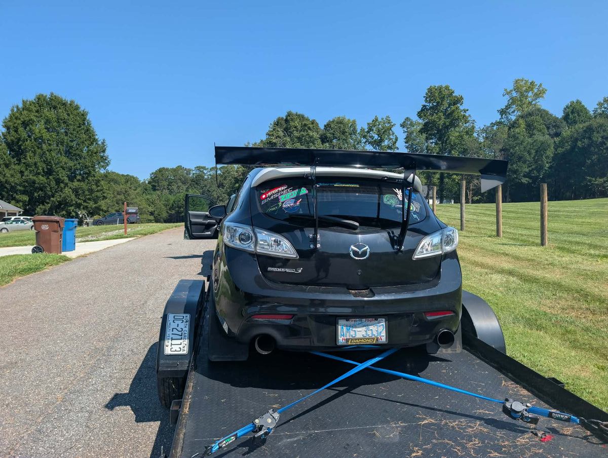 Mazdaspeed3 Gen2 BL race car with the Epsilon+ TC Wing installed, viewed from the rear on a trailer