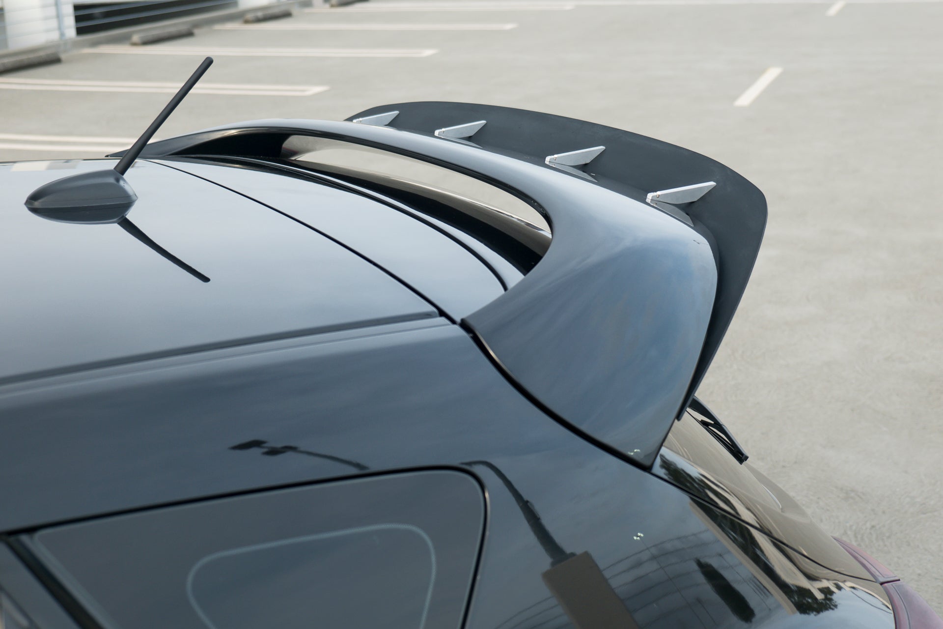 Close-up of the Epsilon+ spoiler extension mounted on a black Mazdaspeed3 Gen2 hatch