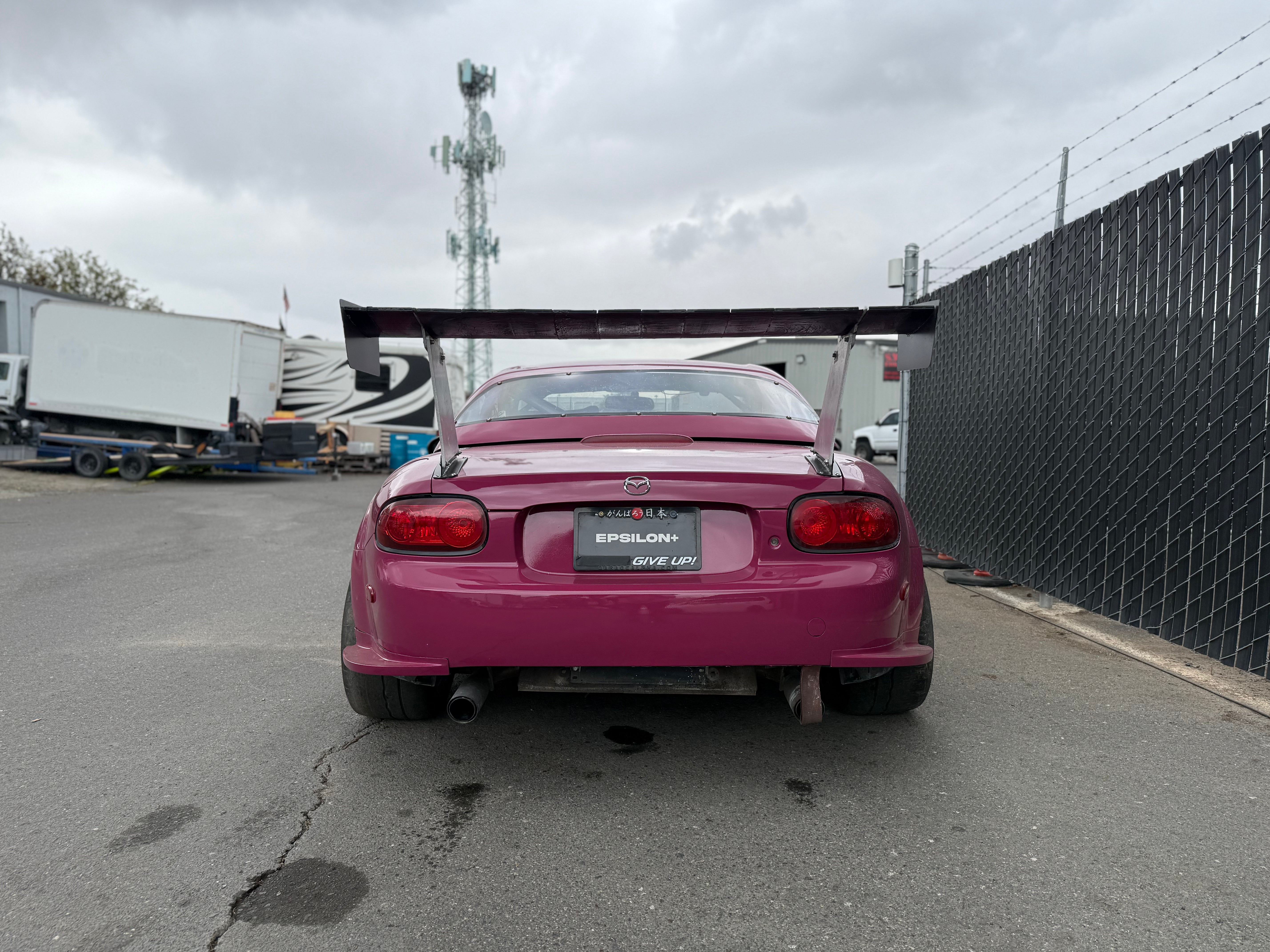Rear view of a pink Mazda MX-5 Miata NC with the full Epsilon+ aero kit