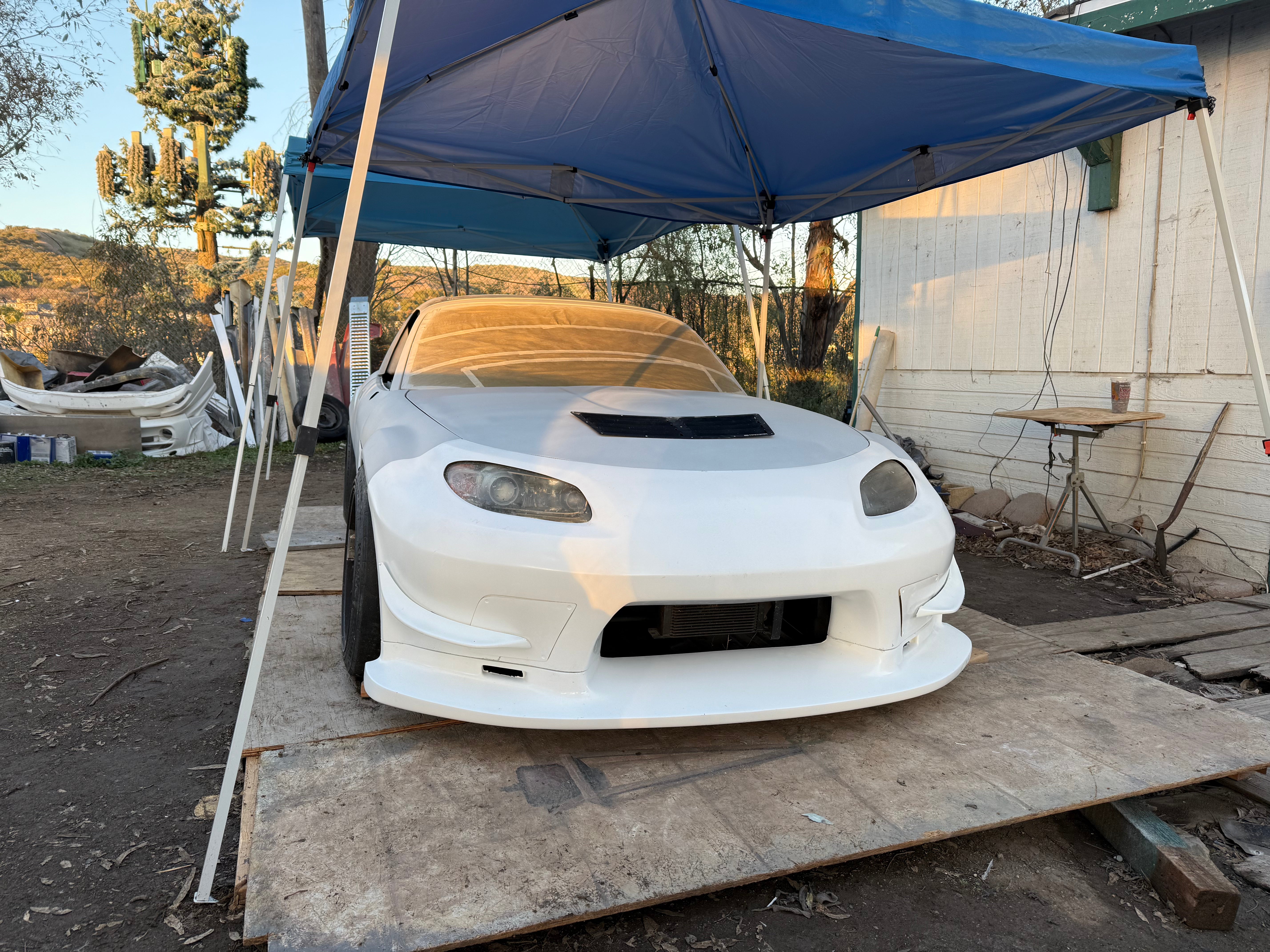 Front view of a white Mazda MX-5 Miata NC with the unpainted Epsilon+ aero kit