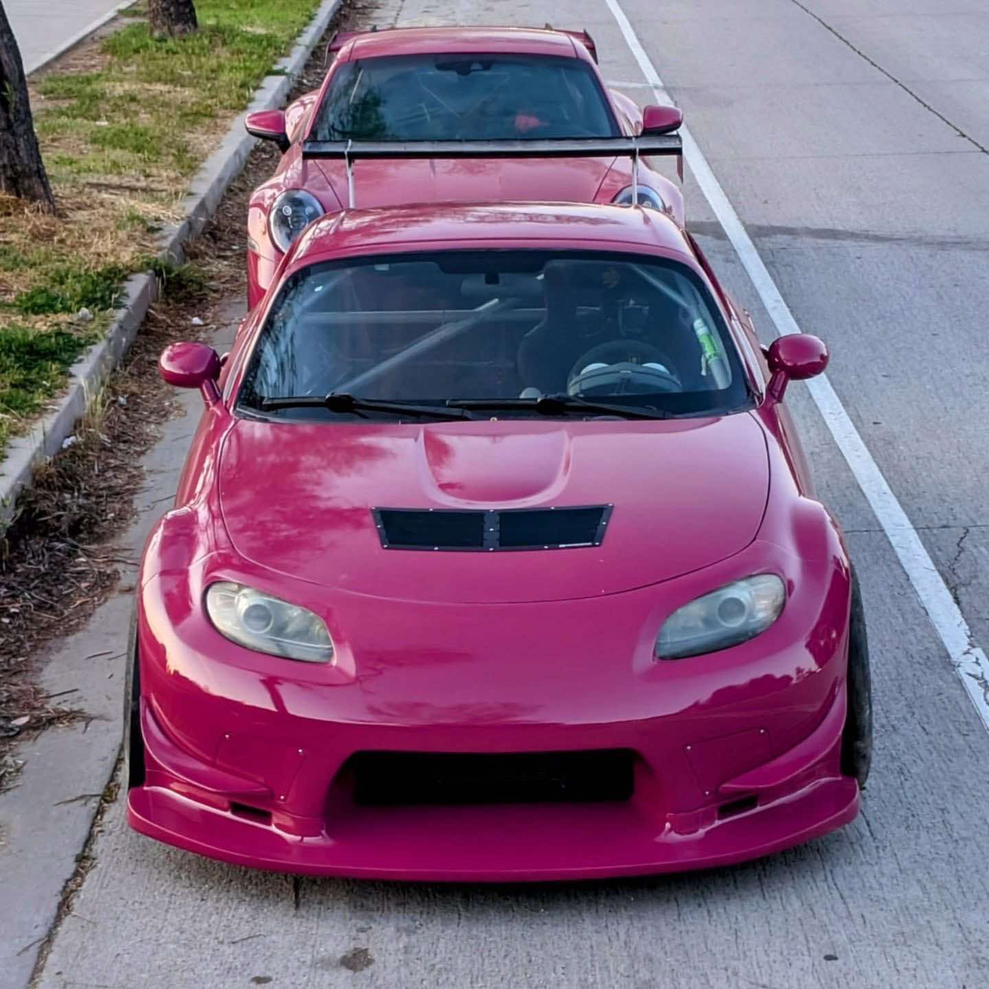 Pink Mazda MX-5 Miata NC with front bumper parked at the roadside