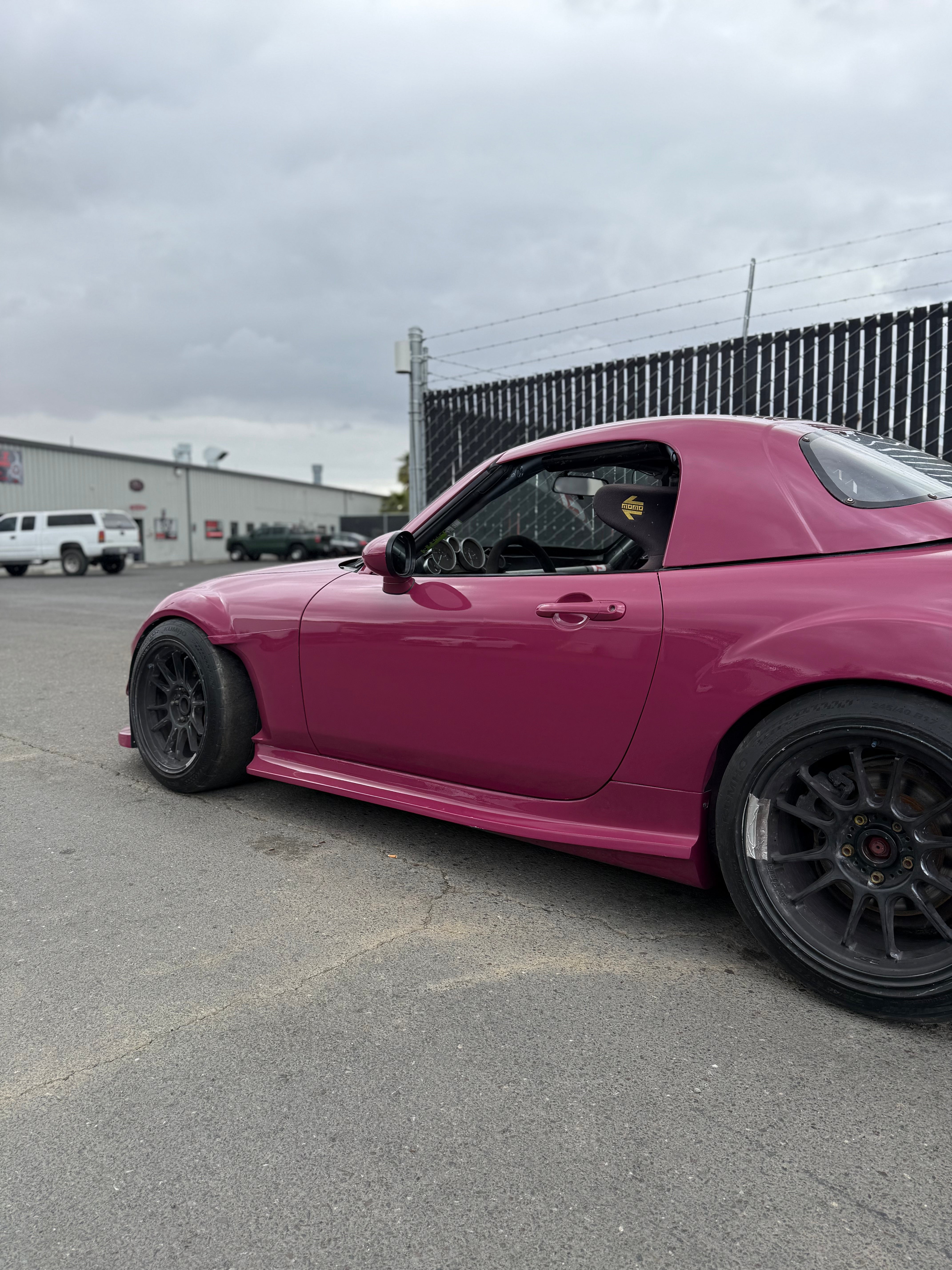 Side-rear view of a pink Mazda MX-5 Miata NC with Epsilon+ side skirts