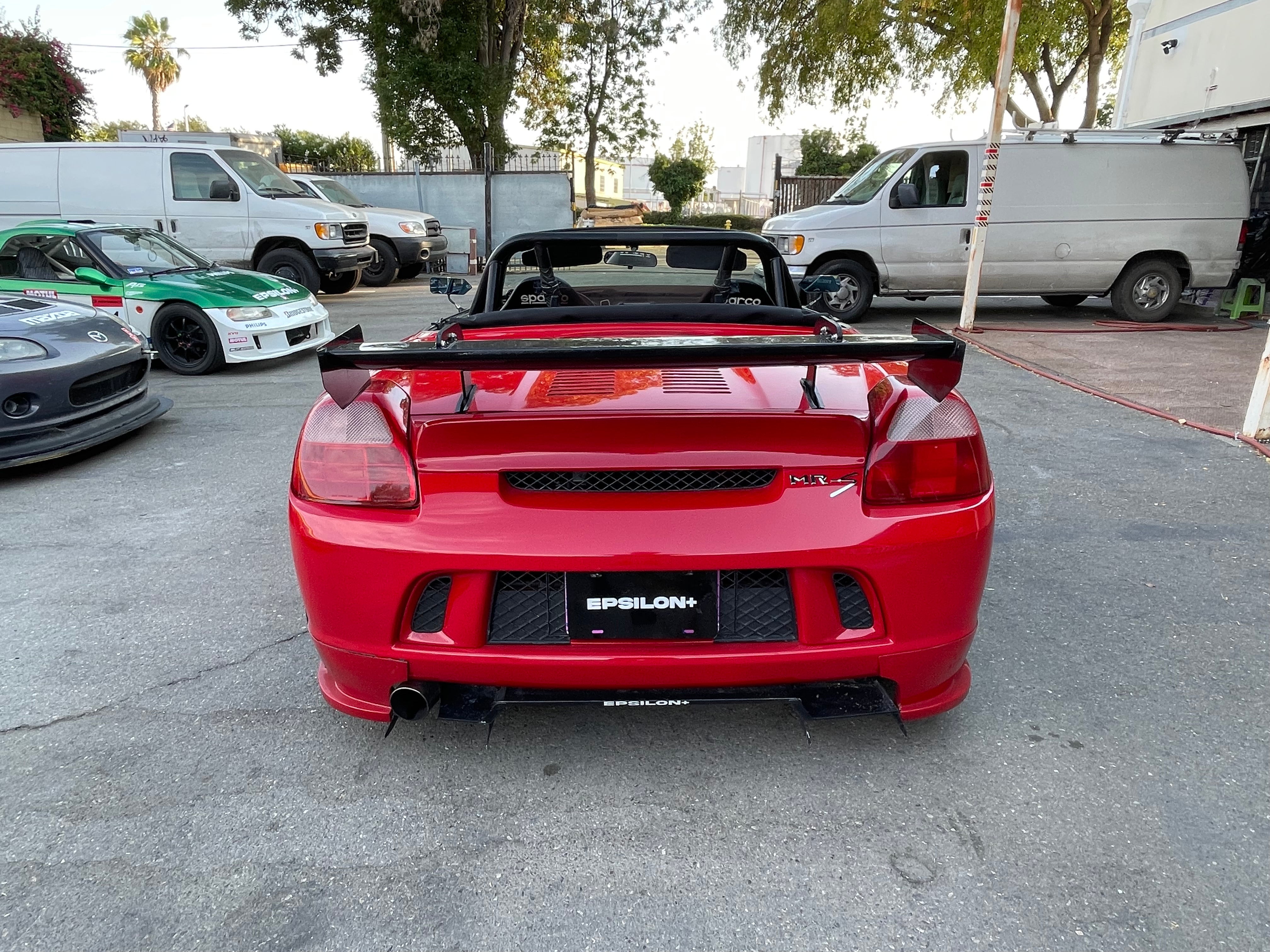 Rear view of a red Toyota MR2 Spyder with the Epsilon+ rear wing and diffuser