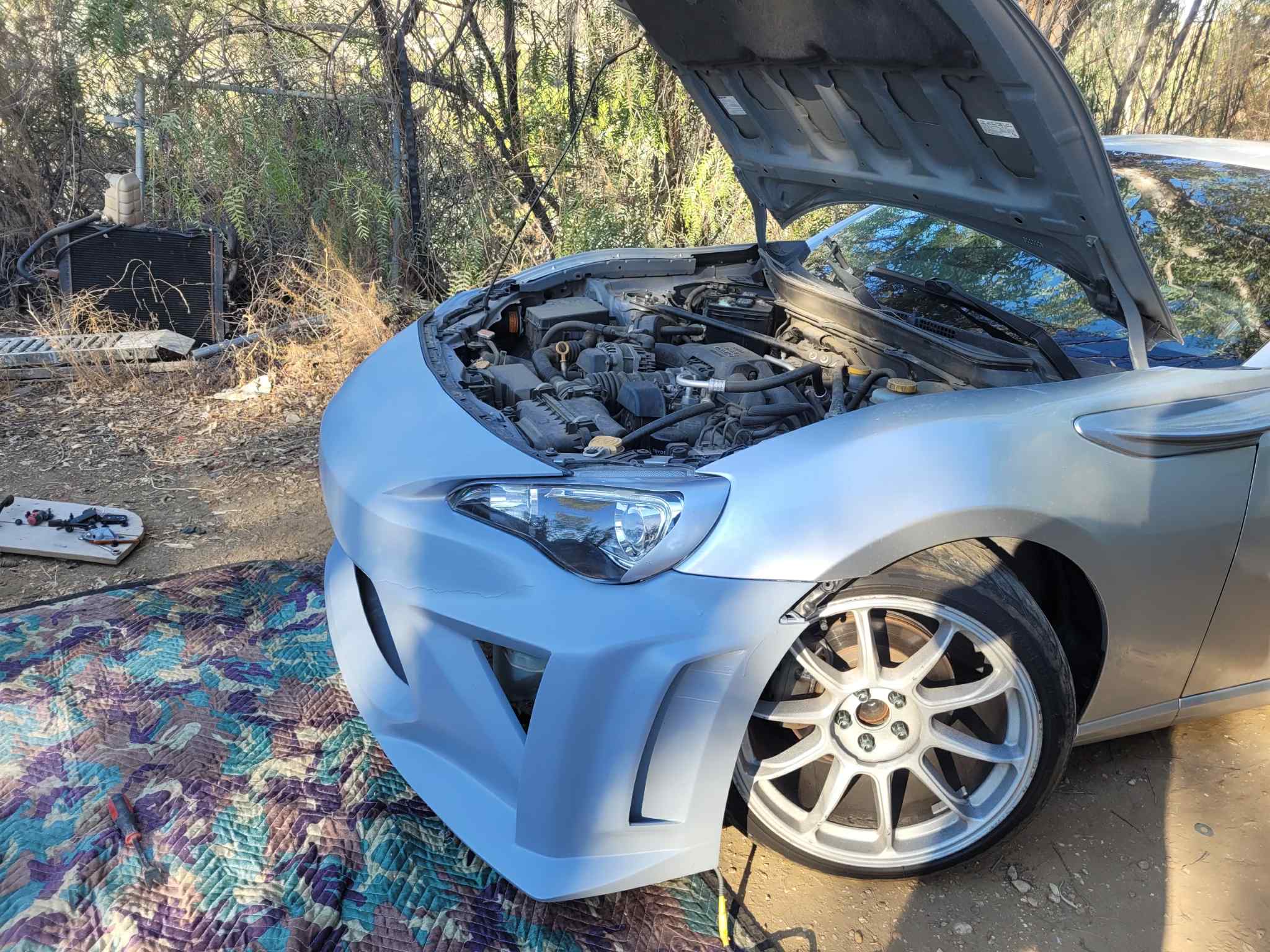 Light blue Subaru BRZ with the Epsilon+ front bumper during fitment