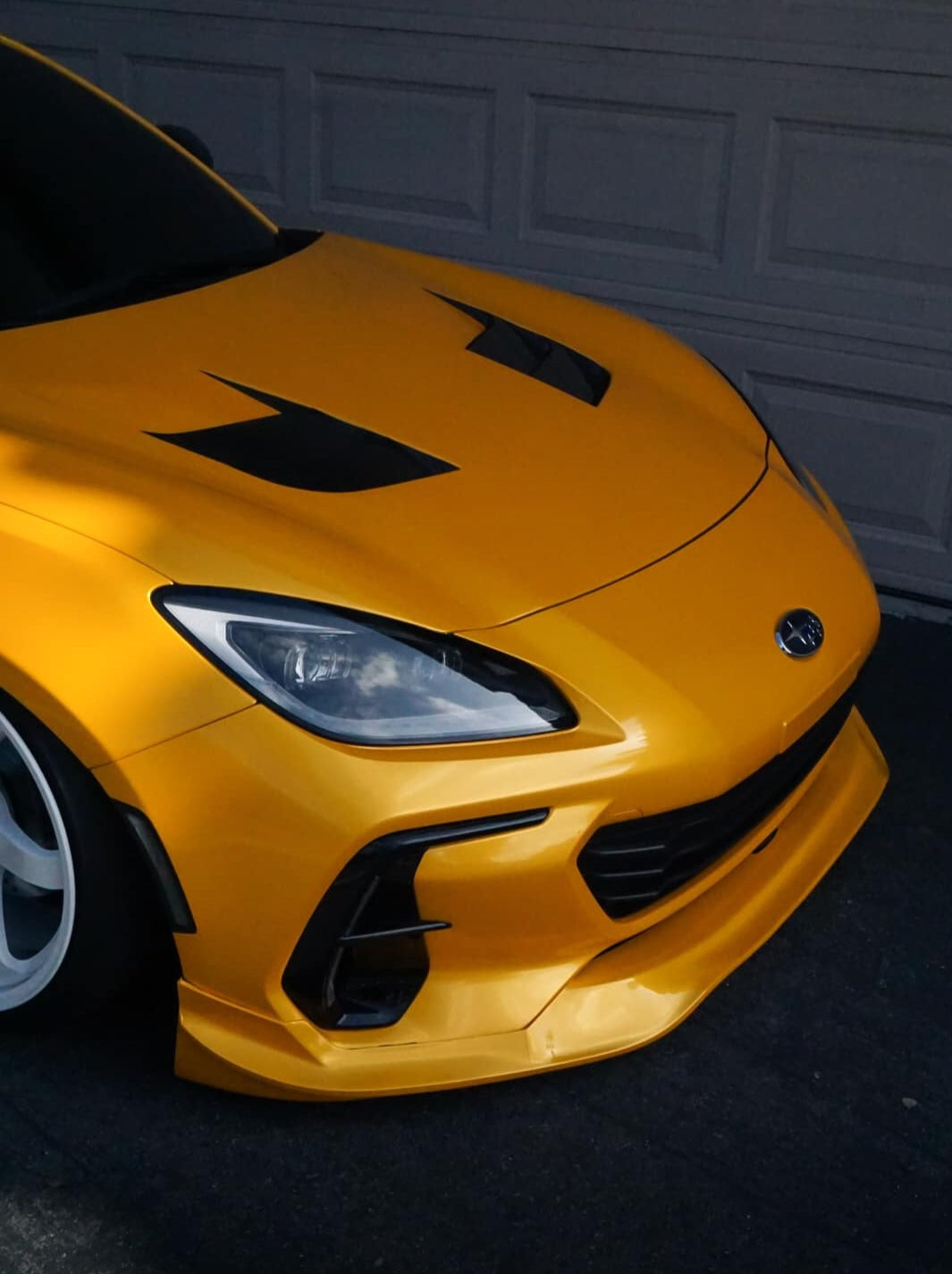 Close front view of a yellow Subaru BRZ ZN8 with the Epsilon+ front lip