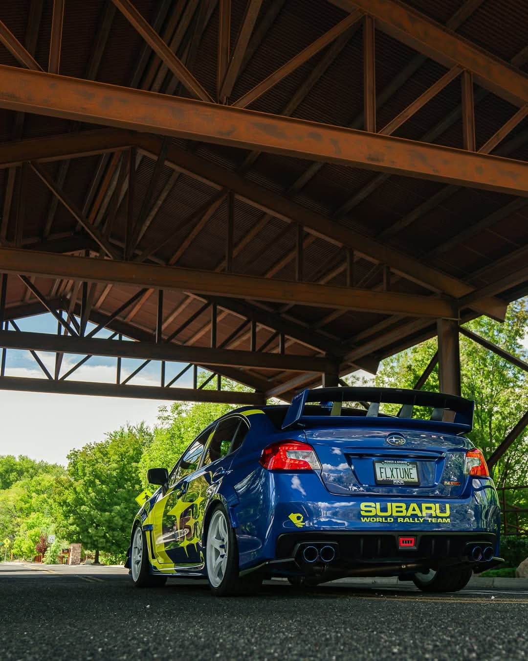Blue Subaru WRX VA in World Rally Team livery with the Epsilon+ WRC wing, rear three-quarter view