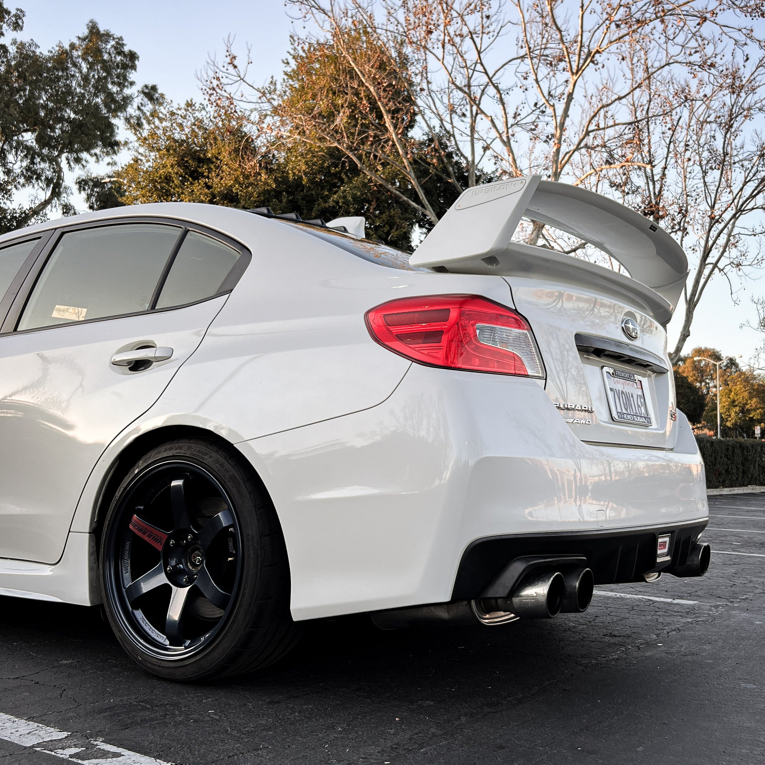 Rear three-quarter view of a white Subaru WRX VA with the Epsilon+ WRC wing