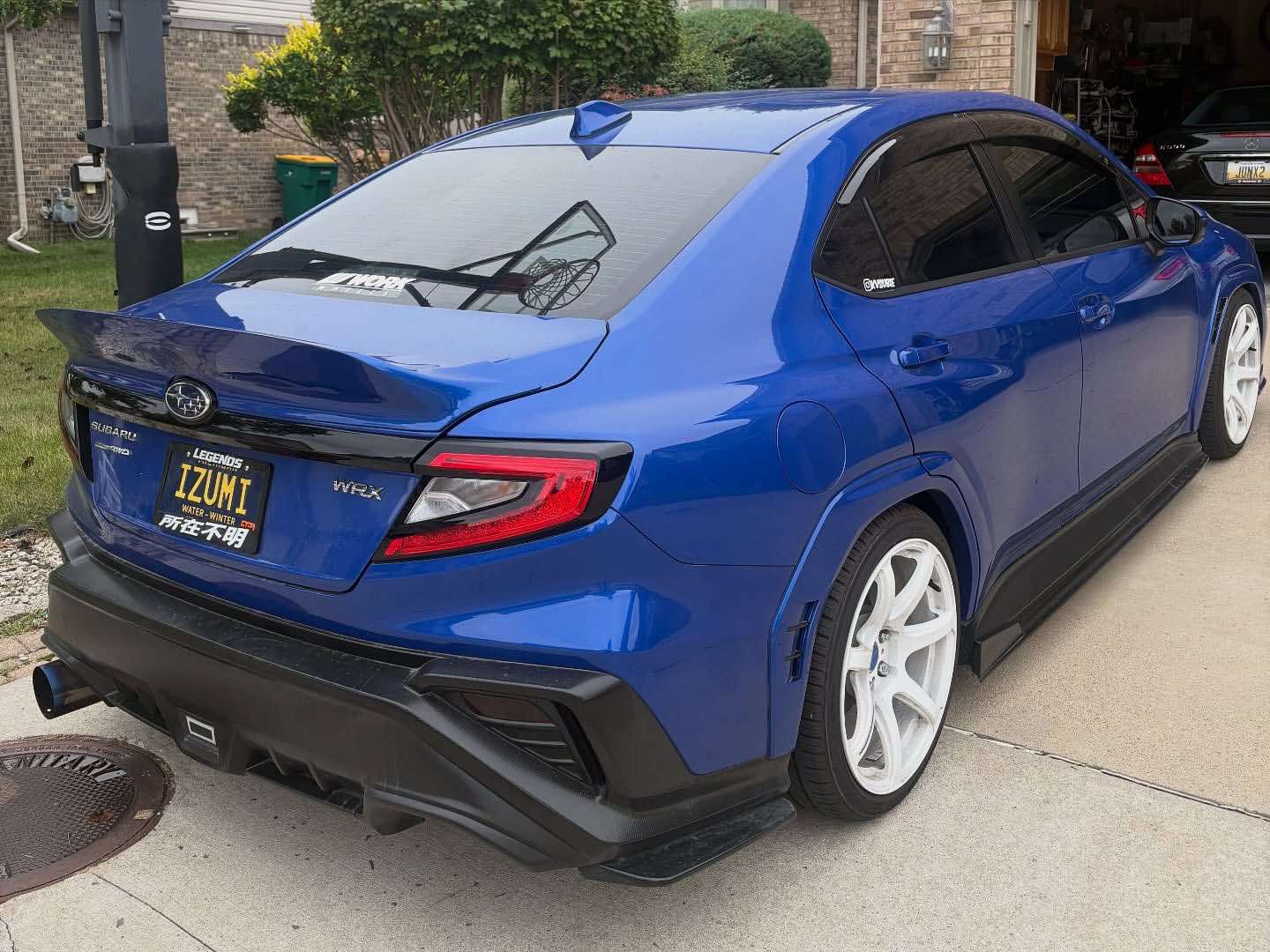 Rear three-quarter view of a blue Subaru WRX VB with rear duckbill and diffuser