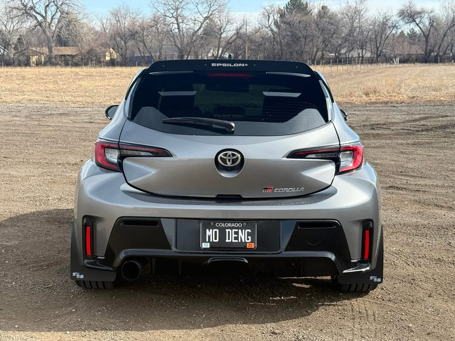 Rear view of a gray GR Corolla with spoiler extension on the OEM wing
