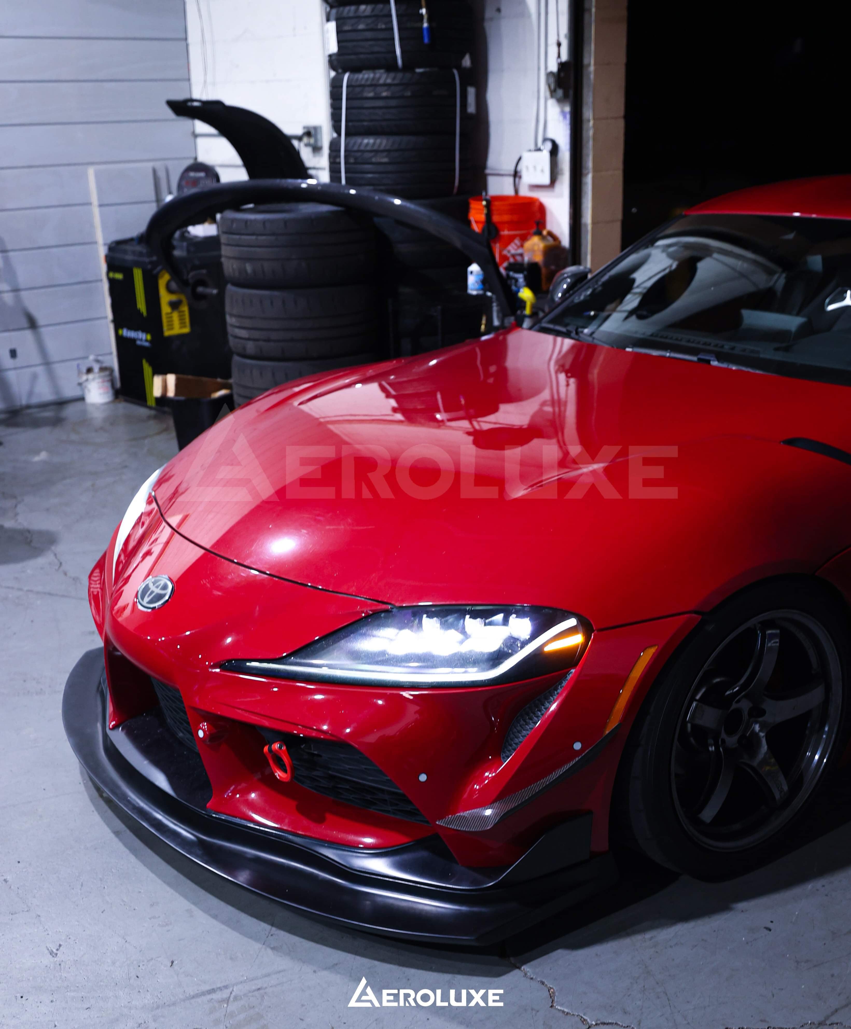 Front view of a red Toyota GR Supra with the GT4-spec front lip