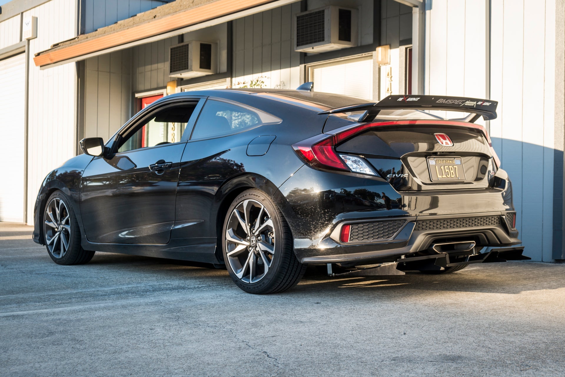 Rear three-quarter view of a black Civic Hatchback with universal diffuser installed