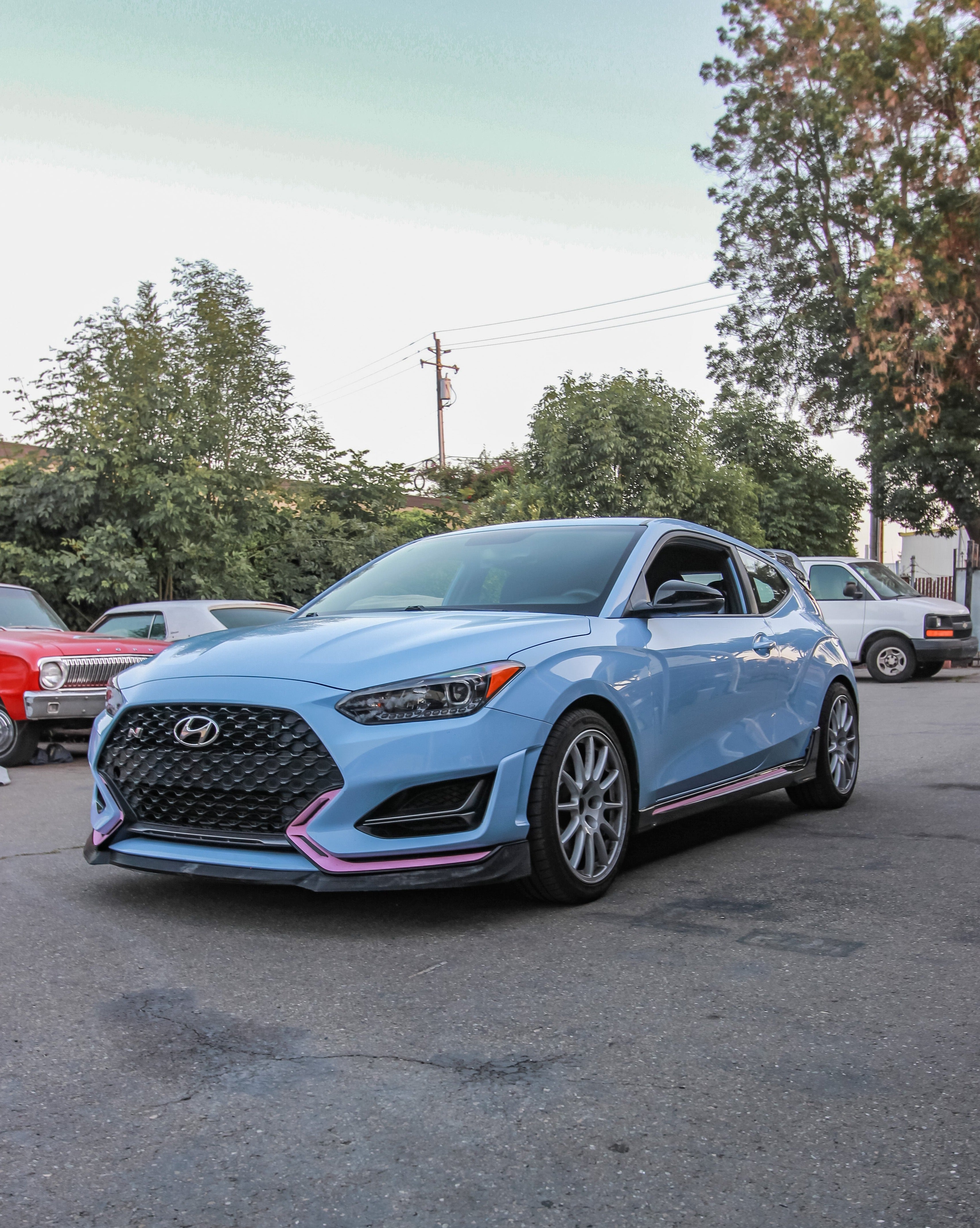 Hyundai Veloster N with front lip parked outdoors, front three-quarter view