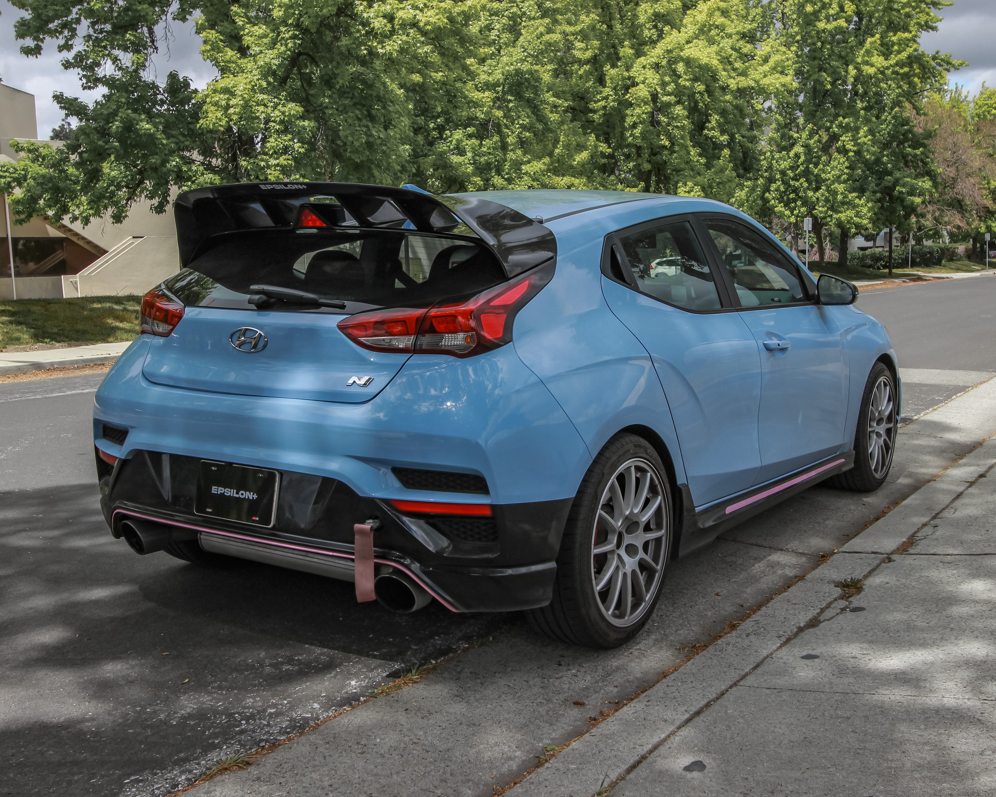 Rear three-quarter view of a blue Veloster N with WRC Wing V2 parked on a driveway