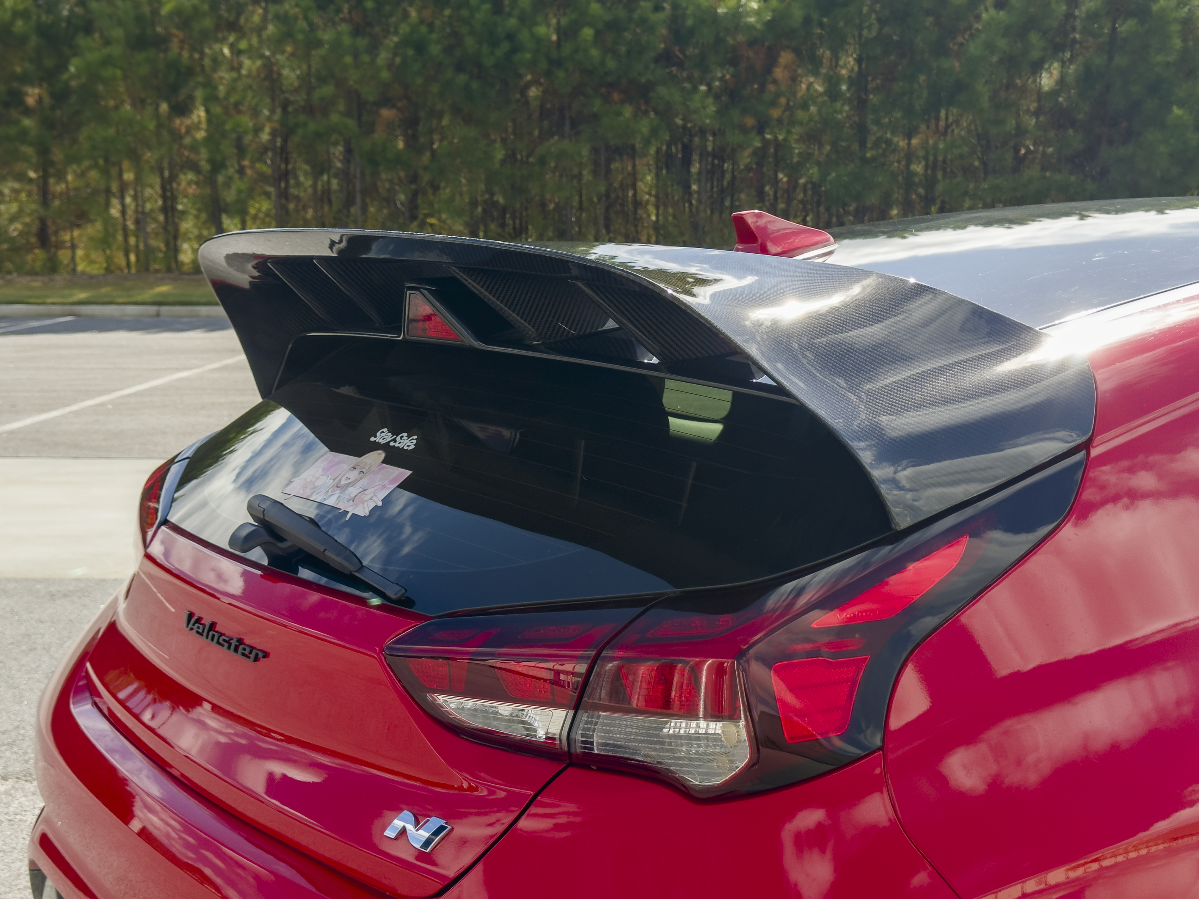 Rear view of a blue Veloster N with WRC Wing V2, taillights and Epsilon+ badge visible