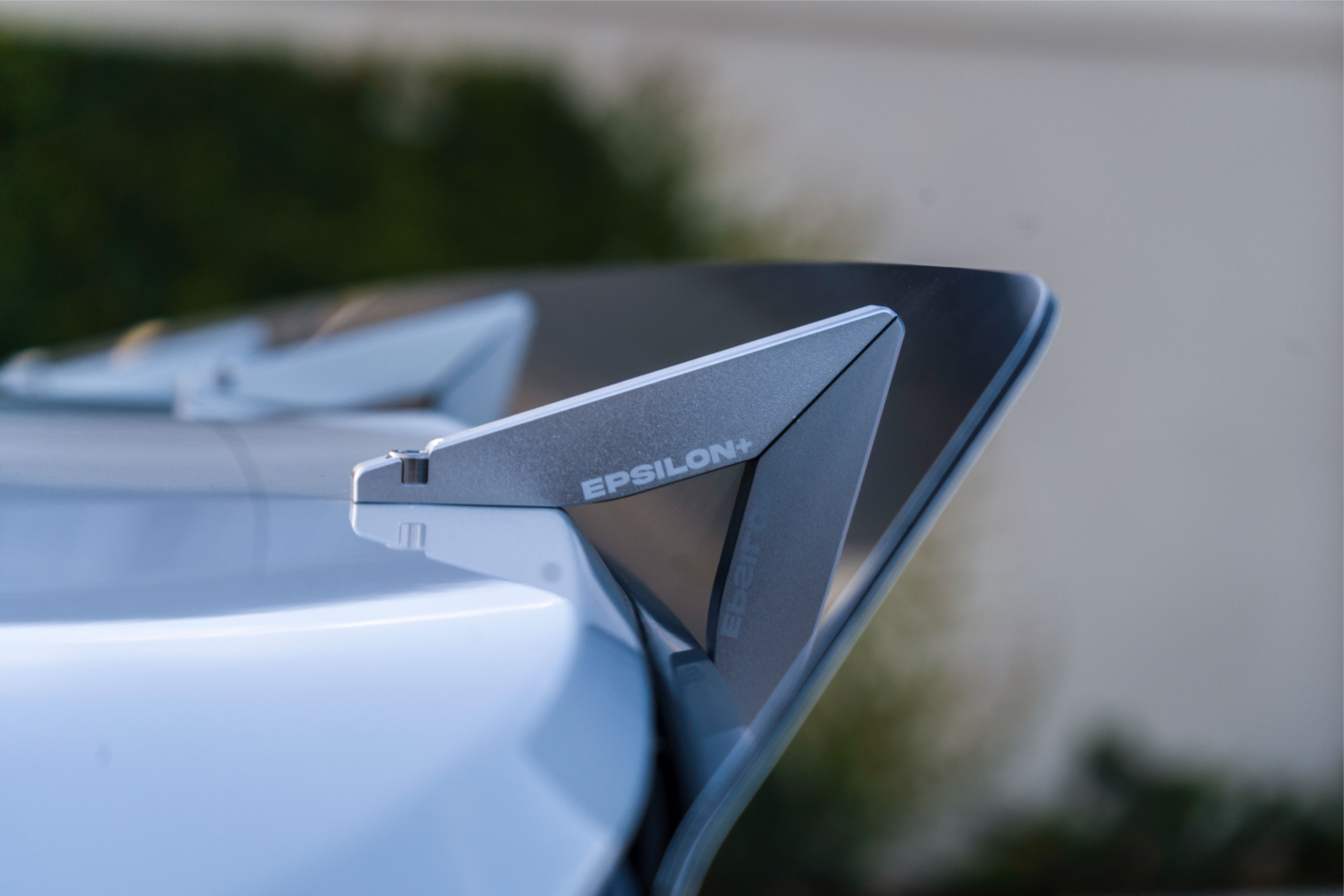 Close-up of the spoiler extension mounted on a white Veloster R roofline