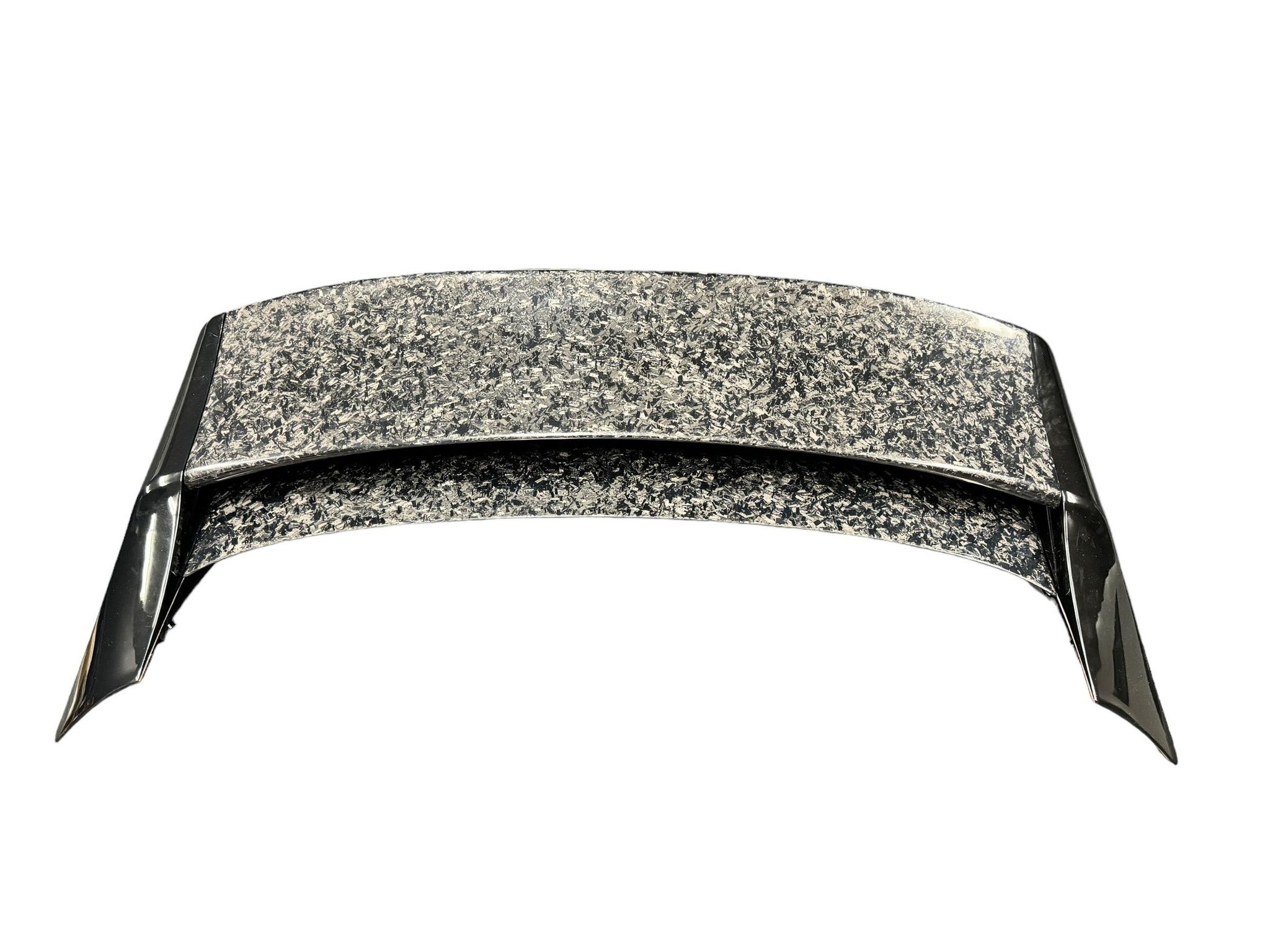 Close-up of the carbon fiber WRC Wing V3 blade texture and mounting tab