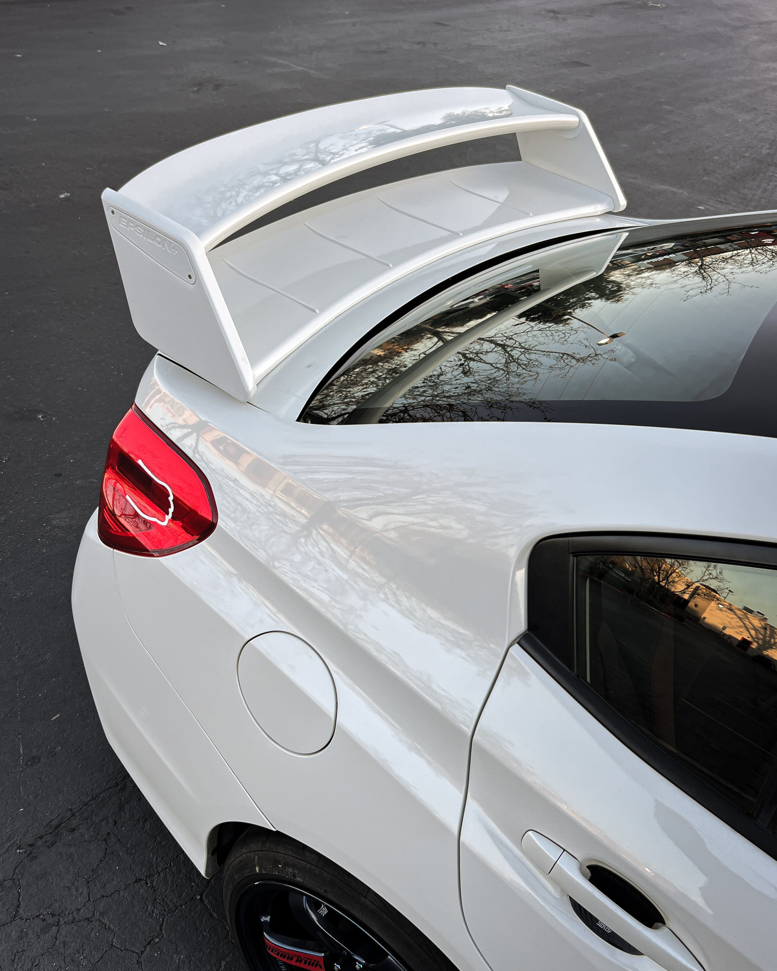 Rear three-quarter view of the WRC wing profile on a white Subaru WRX VA