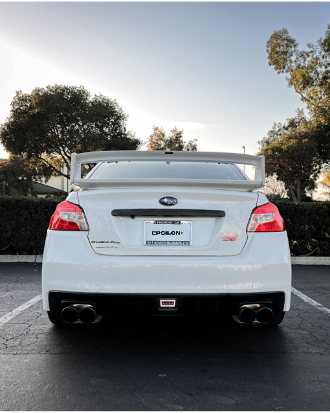 Rear view of a white Subaru WRX VA with the WRC wing at dusk