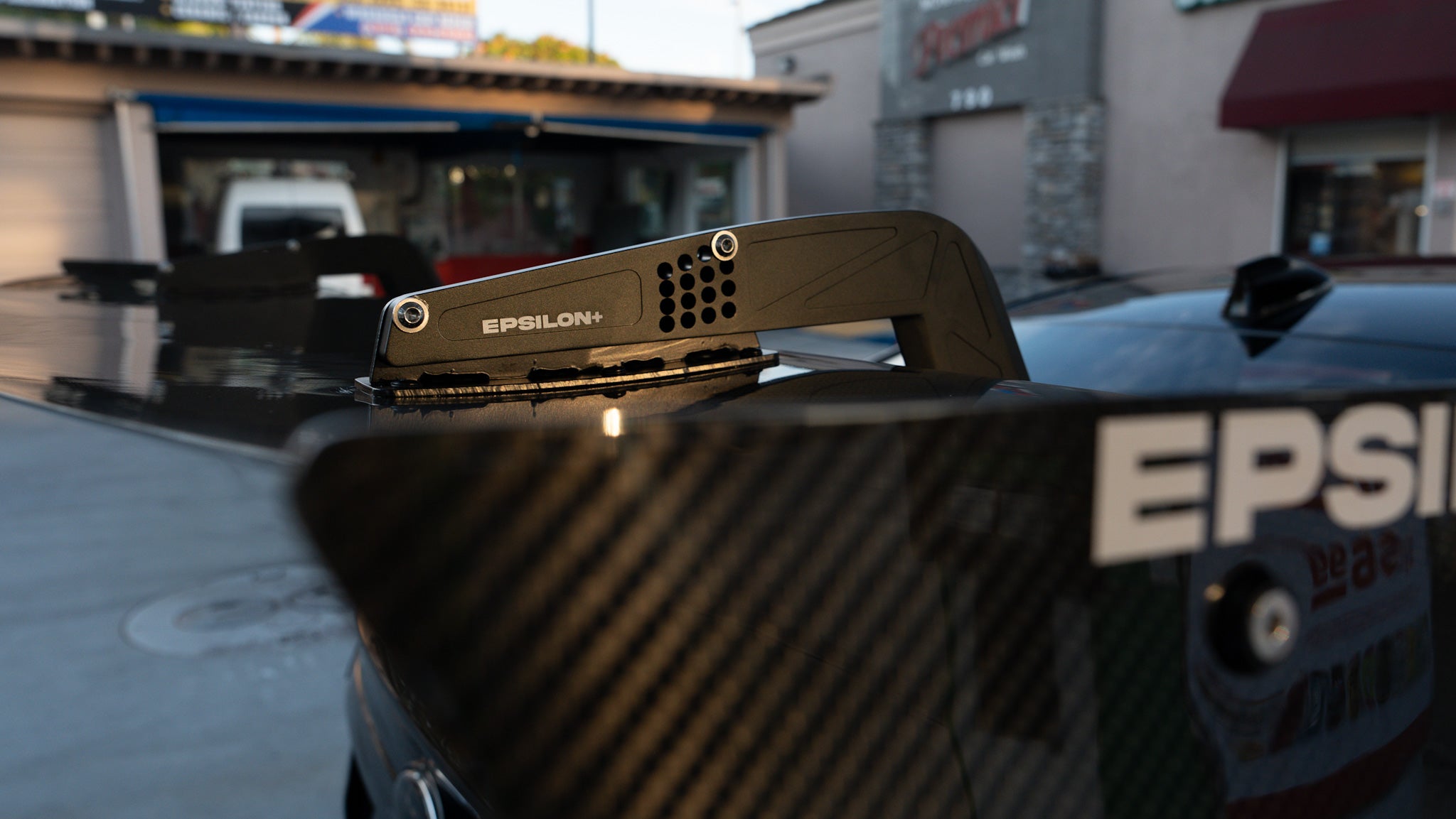 Close-up of the carbon fiber GT wing blade and Epsilon+ endplate on a Subaru WRX VB
