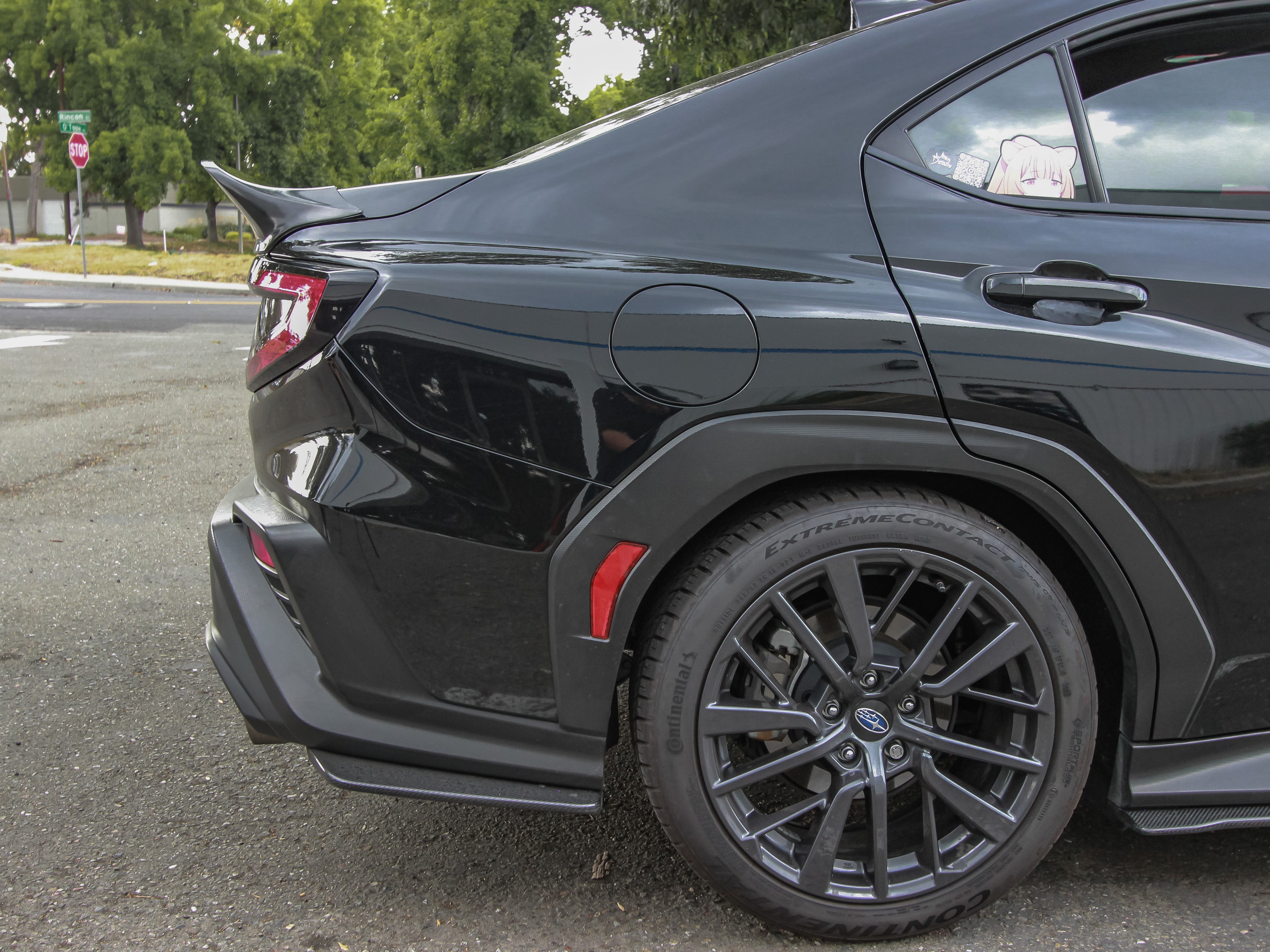 Side-rear view of a black Subaru WRX VB with the rear duckbill spoiler