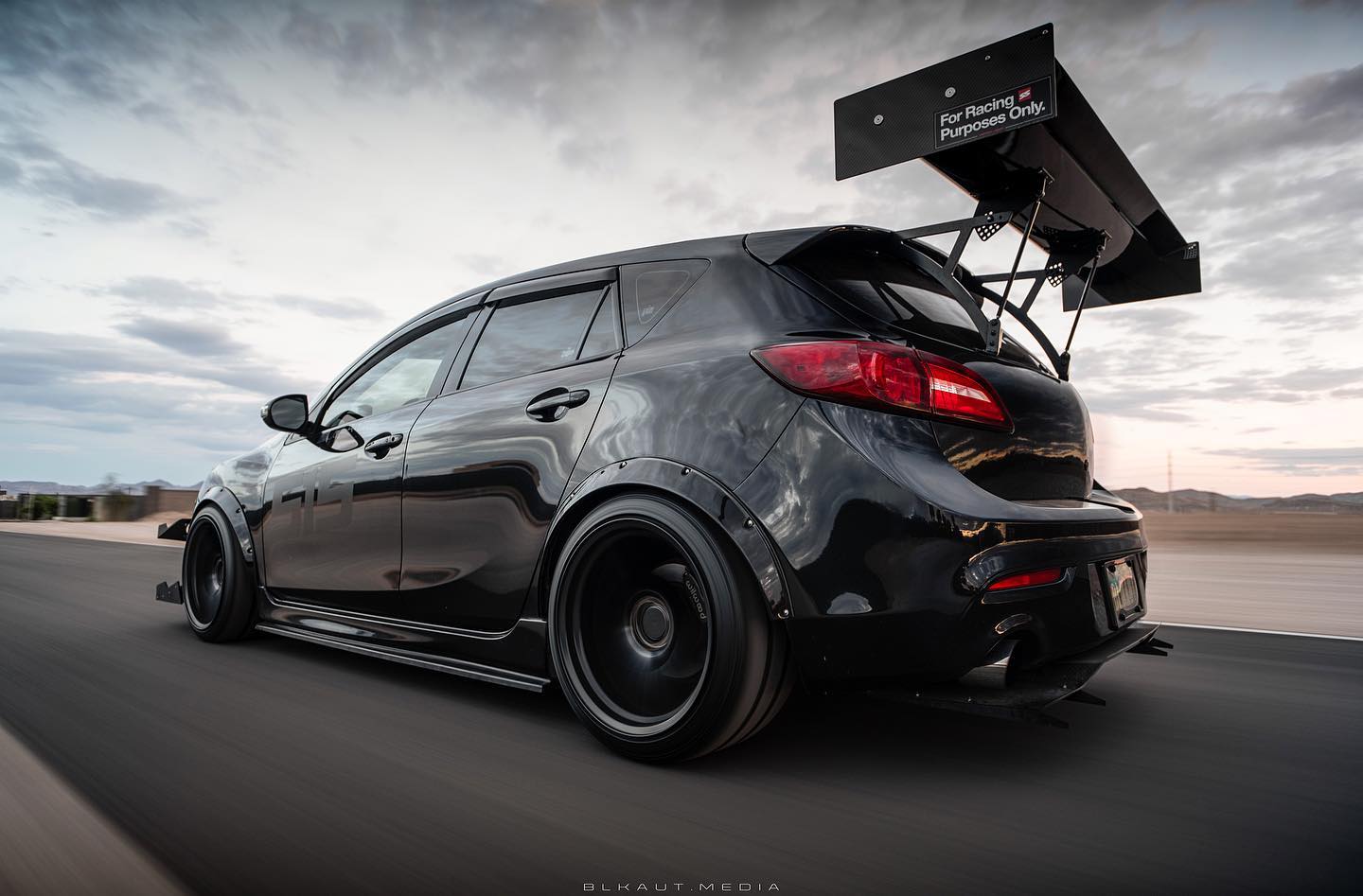 Black Mazdaspeed3 Gen2 with V1+ rear diffuser and GT wing, rear three-quarter view