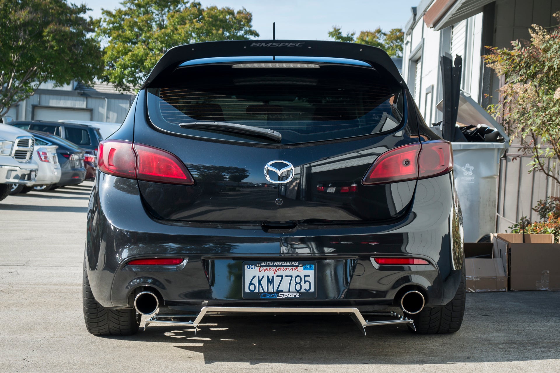 Rear-on view of a black Mazdaspeed3 Gen2 with the V1+ diffuser and dual exhaust